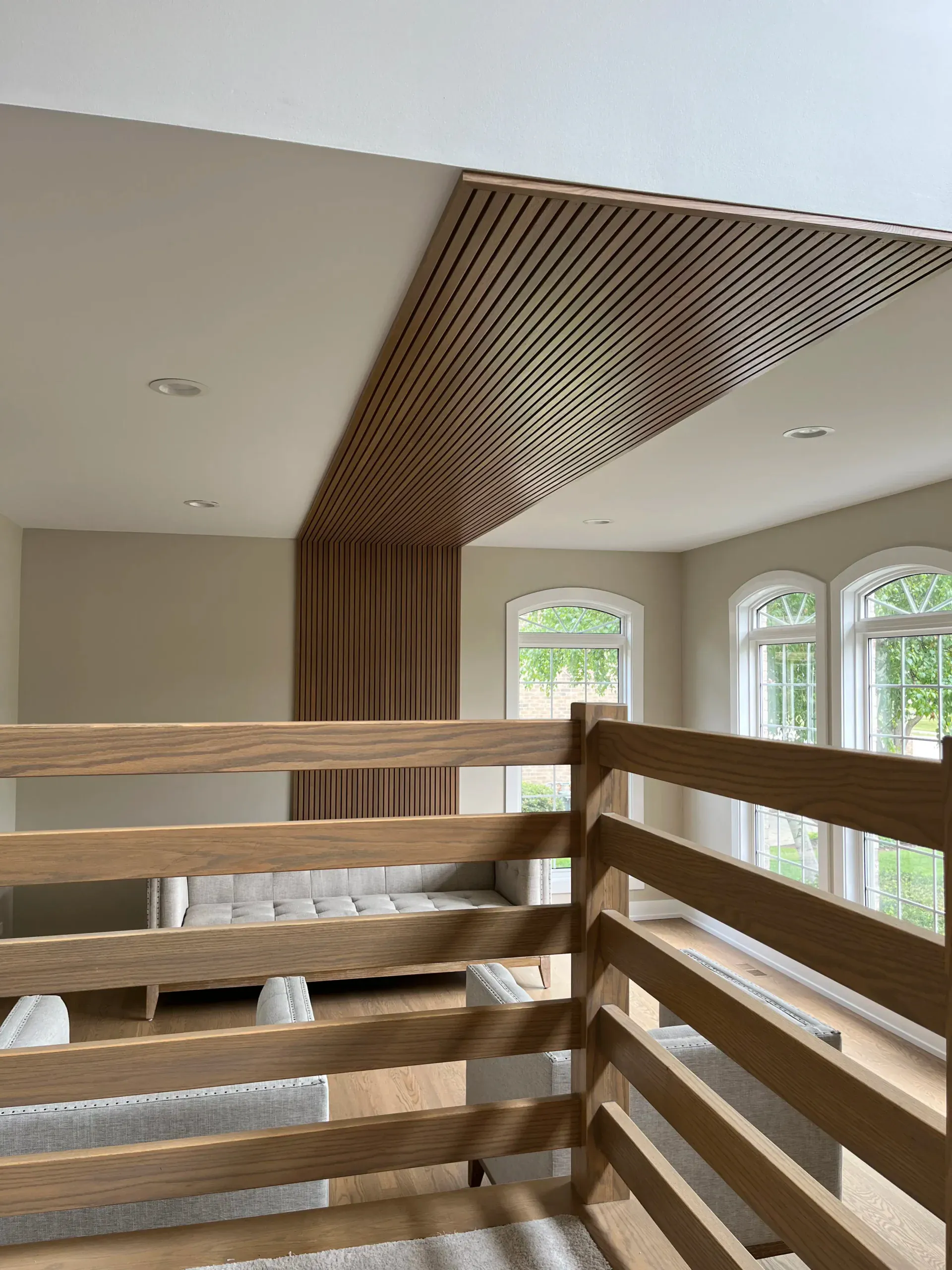 Wood-slat angled ceiling with arched windows