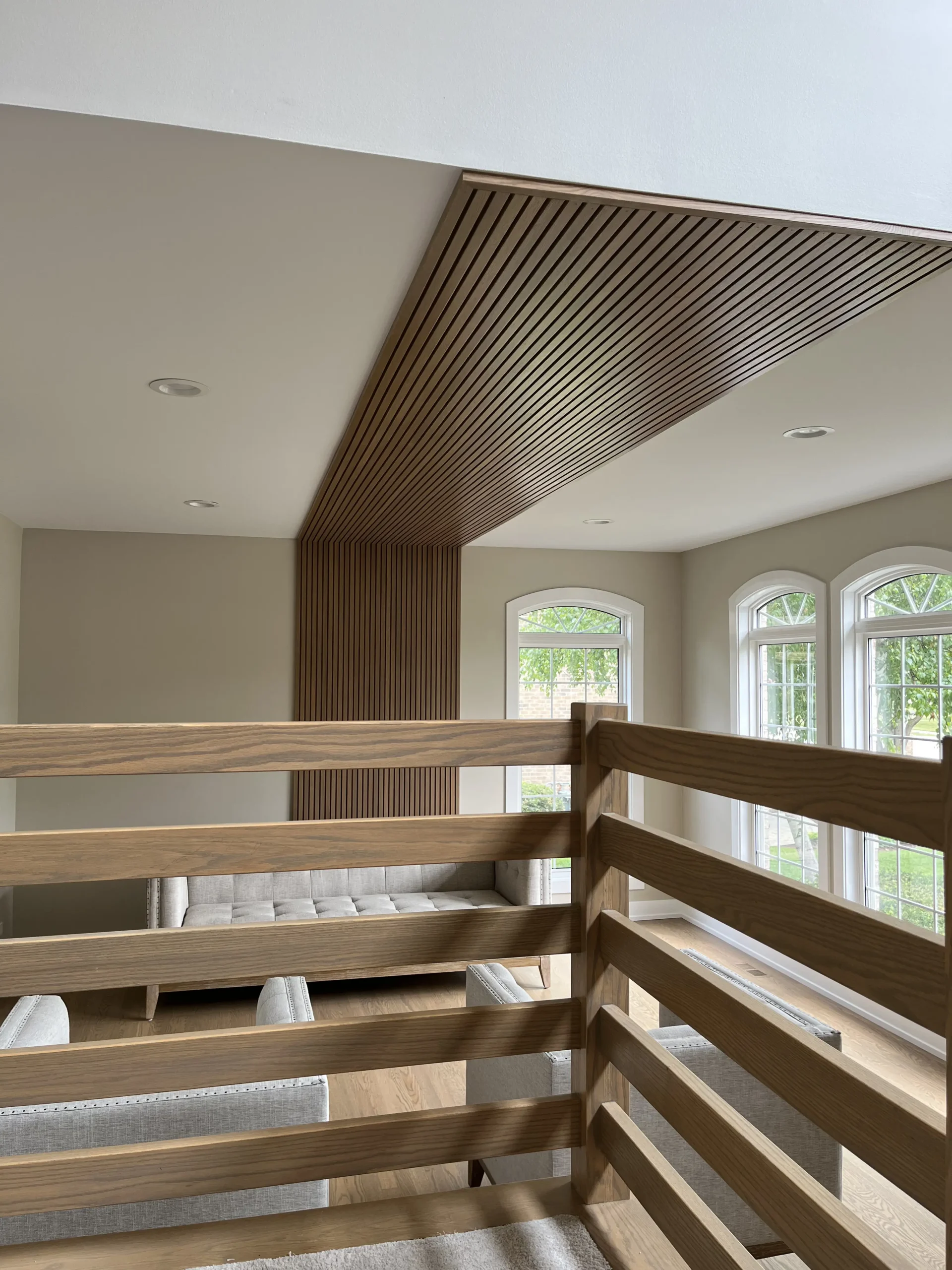 Wood-slat angled ceiling with arched windows